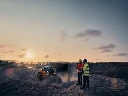 Two men talking at work site